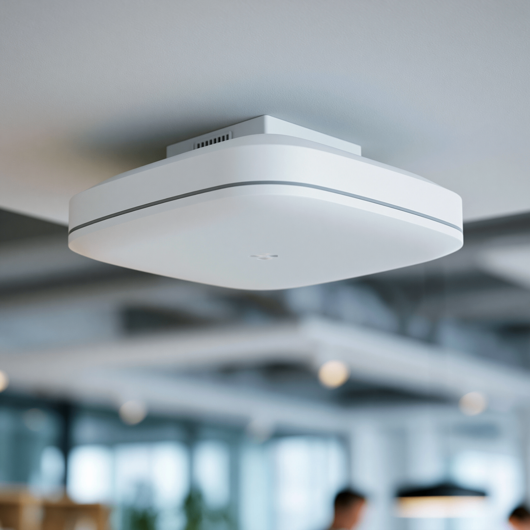 Ceiling-mounted business-grade Wi-Fi access point in a modern office