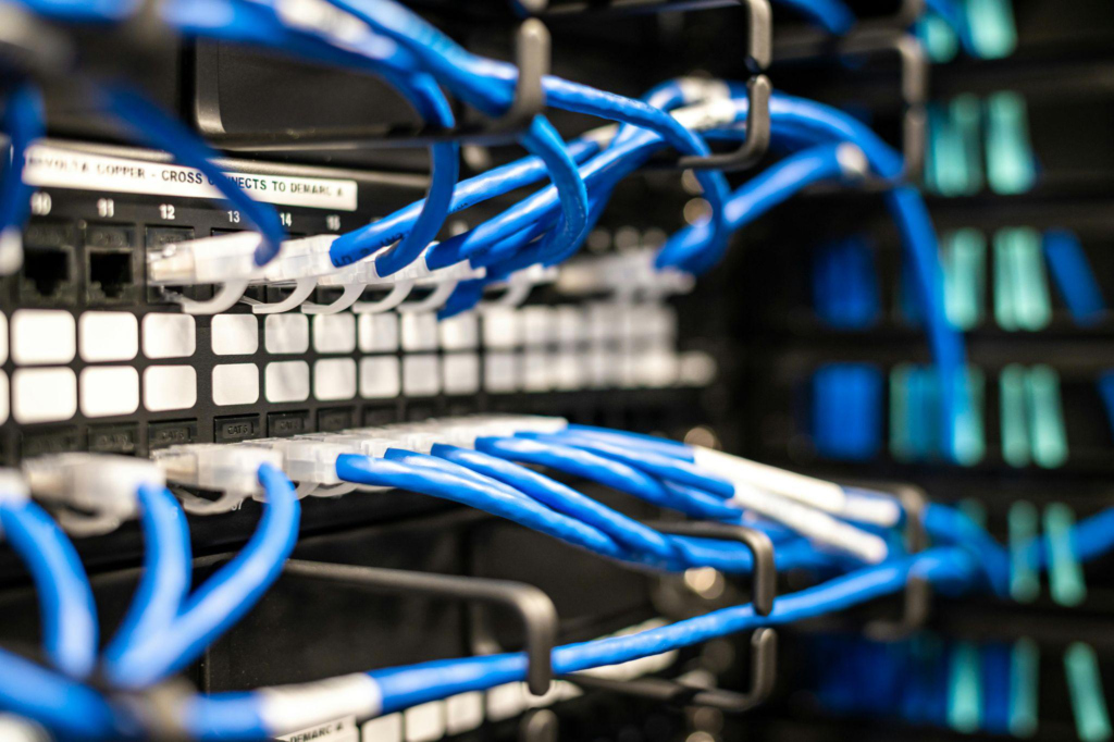 Organized blue structured cabling connected to a server rack.