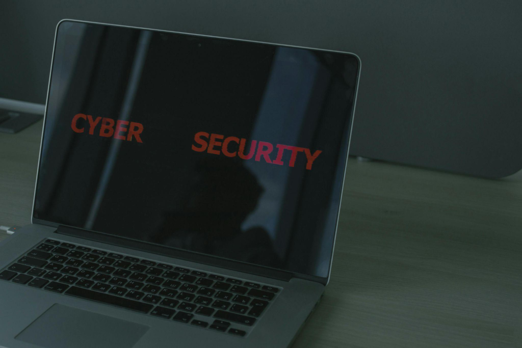 Laptop screen displaying the words “Cyber Security” in red, symbolizing a cyber threat.