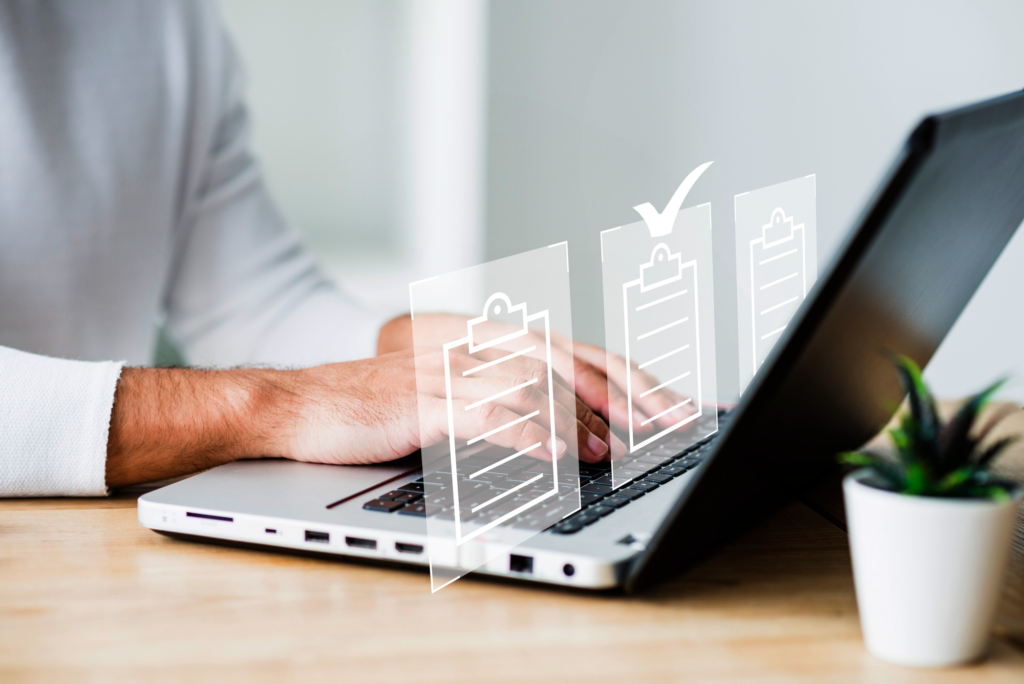  Person typing on a laptop with digital checklist icons representing policies.