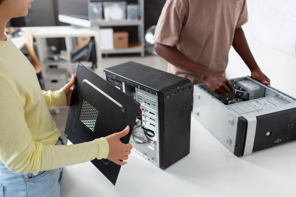 Two technicians are repairing desktop computers.