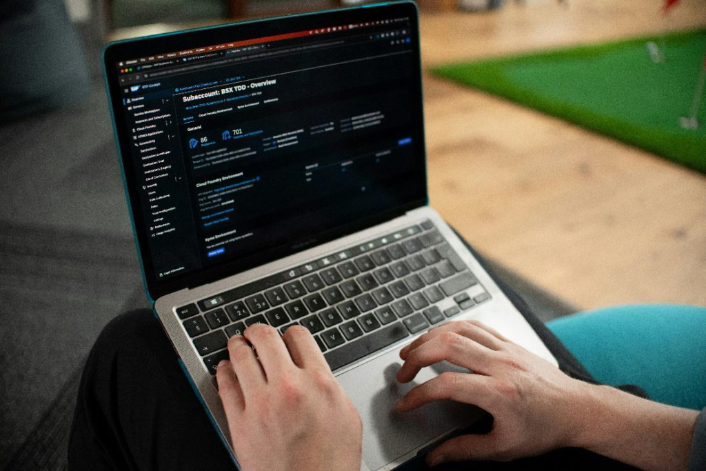 User managing cloud dashboard on laptop for remote business operations.