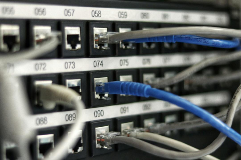 Connected Ethernet cables in a network switch representing seamless software integration.